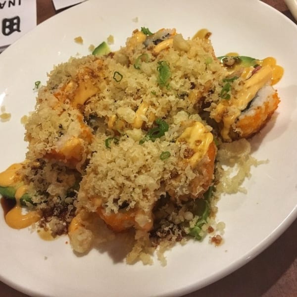Inakaya Japanese Restaurant's crispy sushi rolls, topped with sauce, avocado, and green onions.